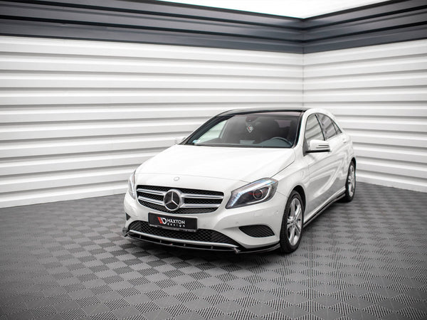A white Mercedes-Benz car is parked in a modern, grey-tiled showroom with striped white and black walls. The front license plate reads "MAXTON design."