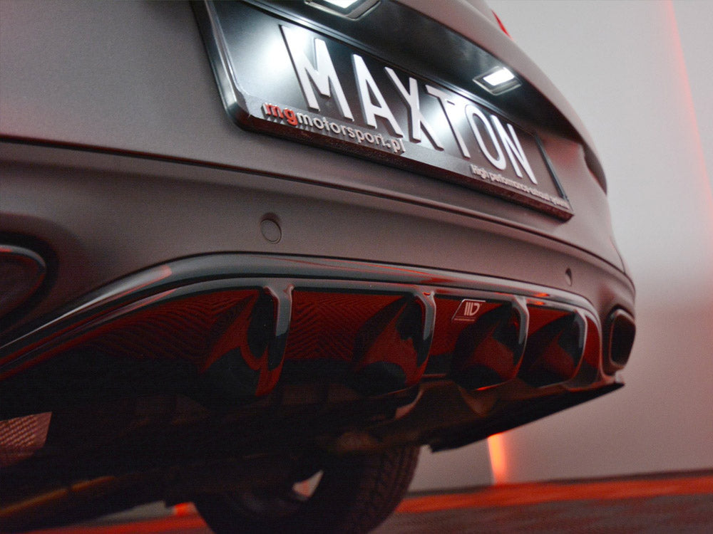 Rear of a car showing a customized diffuser with red accents; a license plate reading "MAXTON" is illuminated. Surrounding environment has a dim, red-lit ambiance.