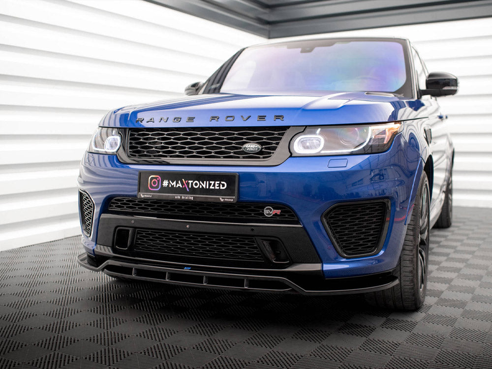 A blue Range Rover is parked indoors on a patterned floor. The license plate displays "#MAXTONIZED," and the environment features white and gray paneling on the walls.