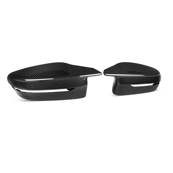 Carbon fiber mirror covers are resting side by side; they have a sleek, glossy finish with a minimalist black-and-white design, set against a plain white background.