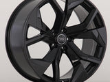A glossy black alloy wheel with a five-spoke design and an Audi logo is displayed against a plain, light background.