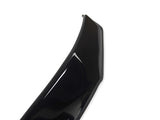 A glossy black car part, possibly a bumper or spoiler, is displayed on a plain white background, highlighting its curved design and shiny surface with a small visible hole.