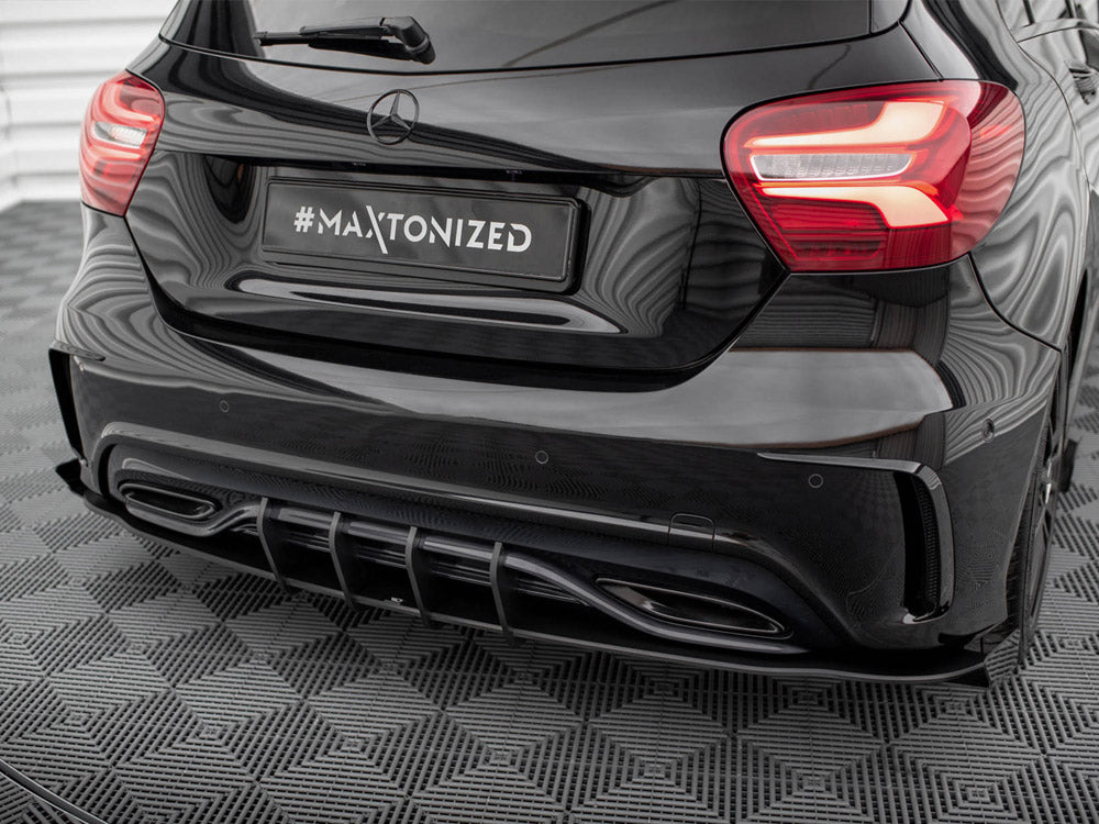 A black car's rear with illuminated tail lights is parked on a patterned surface. The license plate reads "#MAXTONIZED," and the setting appears to be indoors with reflected lights.