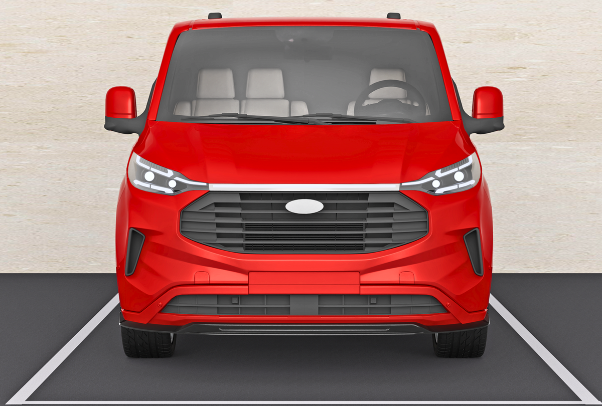 A red van is parked in a designated space, surrounded by a light-colored surface. Its front-facing view showcases headlights, a large grille, and visible side mirrors.