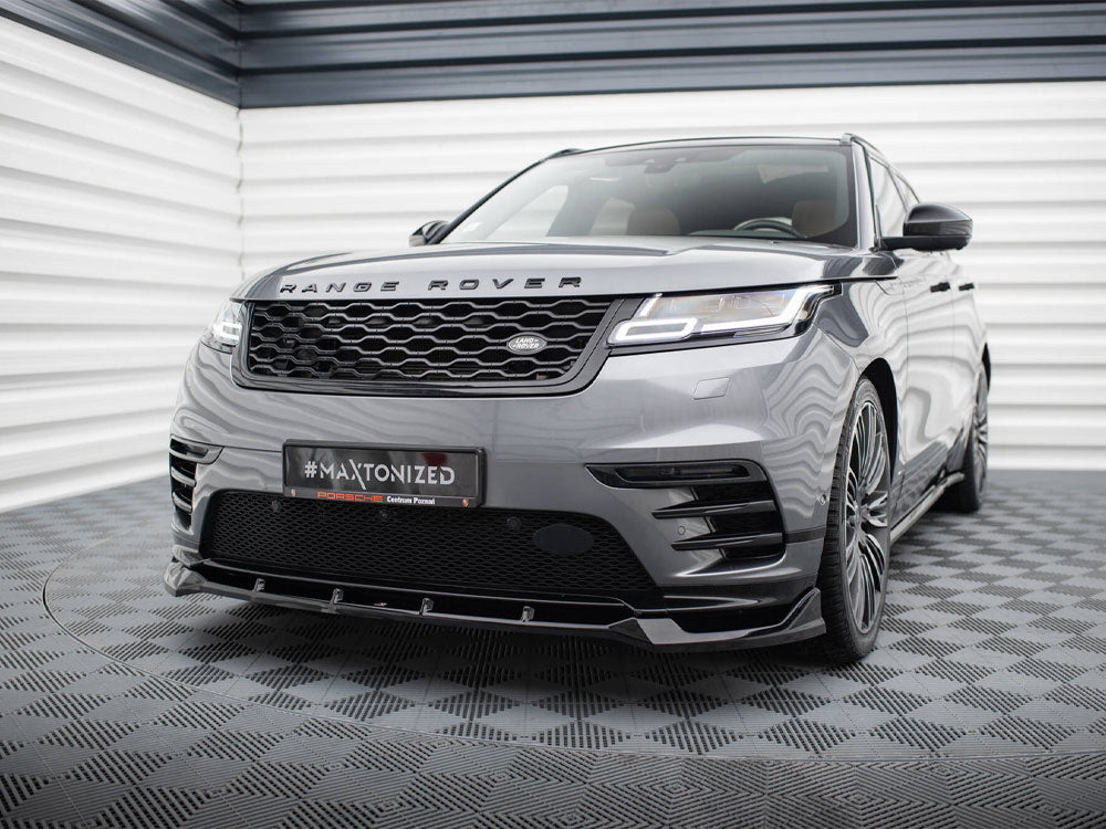 A gray Range Rover is parked in a geometric-patterned room, showcasing a customized front bumper. The license plate reads "#MAXTONIZED Porsche Centrum Poznań."