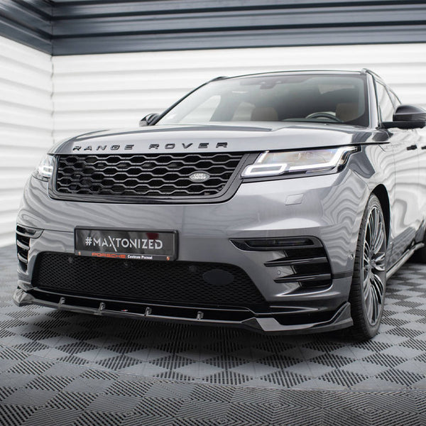 A gray Range Rover is parked in a geometric-patterned room, showcasing a customized front bumper. The license plate reads "#MAXTONIZED Porsche Centrum Poznań."