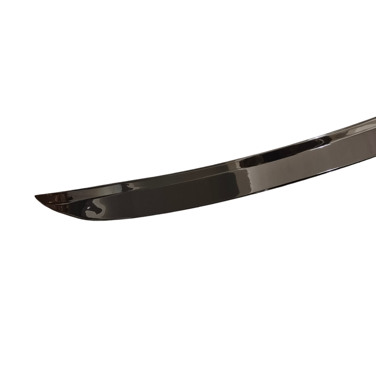 A sleek, curved sword blade with a reflective surface, set against a plain white backdrop, highlighting its polished and slightly arched design.