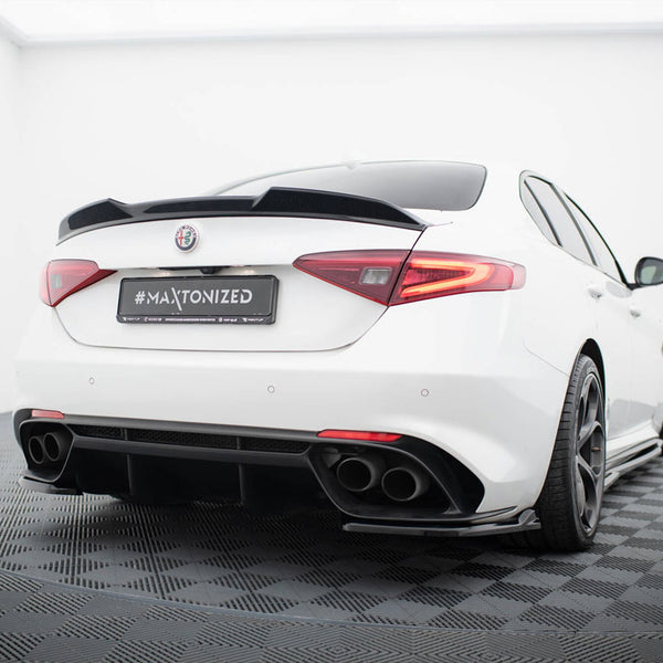 A white sports car, viewed from the rear, sits on a black checkered floor in a bright, minimalist room. The license plate reads "#MAXTONIZED."