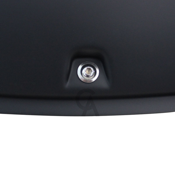 A metallic screw is securely embedded in a smooth, matte black surface. The setting appears industrial, suggesting it may be part of equipment or machinery.