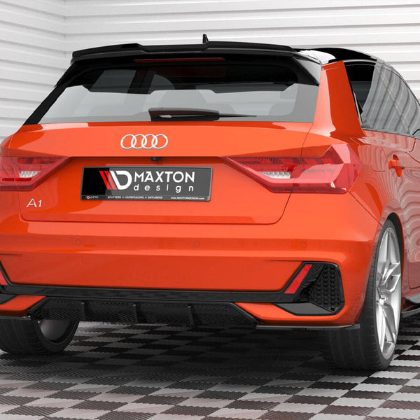 Car sits stationary, showcasing a vibrant orange rear with distinct taillights and sporty accents. License plate reads "MAXTON design." Background consists of white paneled walls and patterned flooring.