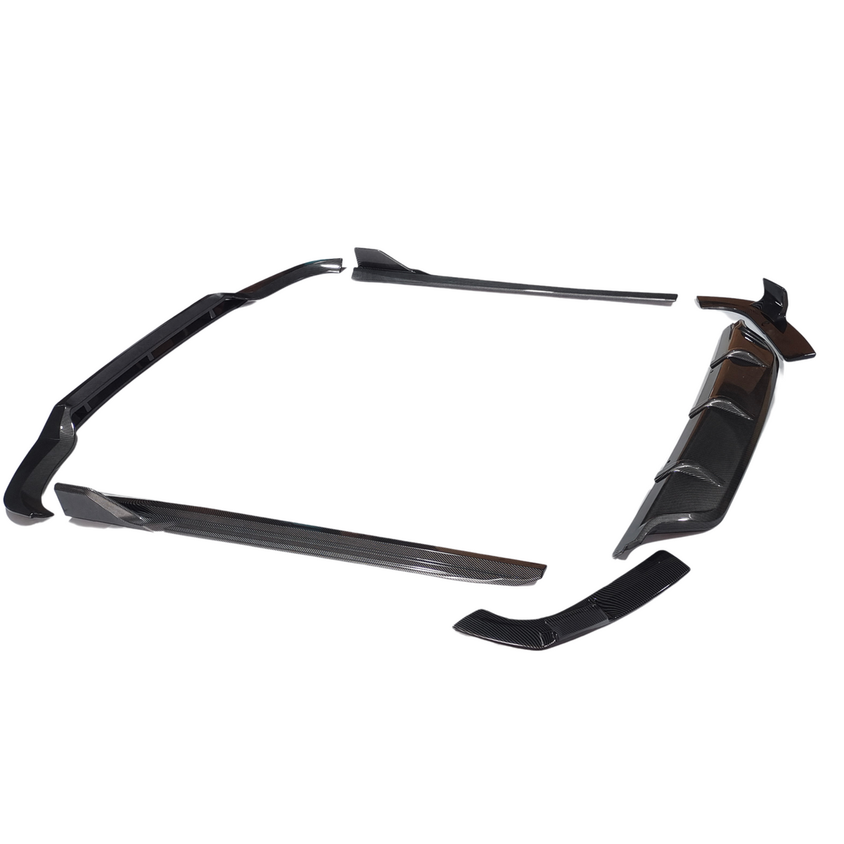 Car body kit components are arranged on a white background, showing a front splitter, side skirts, and a rear diffuser. These are designed to enhance aerodynamic performance and aesthetic appeal.