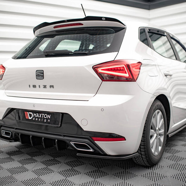 A white car is parked indoors, showcasing its rear view with a "Seat" badge and "Ibiza" text. The environment features a patterned floor and wall. Below is a "Maxton Design" emblem.