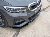 A gray car features a sleek front bumper with dynamic headlights. 
