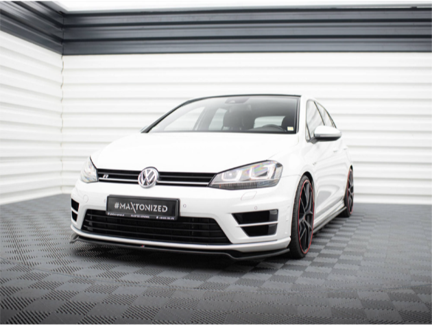 A white Volkswagen car is parked in a showroom with patterned flooring and white walls. Text on the license plate reads "#MAXTONIZED MAEXTON-DESIGN.COM." The setting is bright and modern.