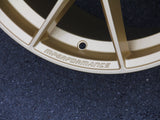 A gold car rim with the text 