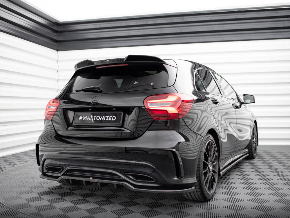 A black car stands stationary in a well-lit, sleek, checkered-floor room. The license plate reads "#MAXTONIZED," and the car features modern taillights and a reflective surface.
