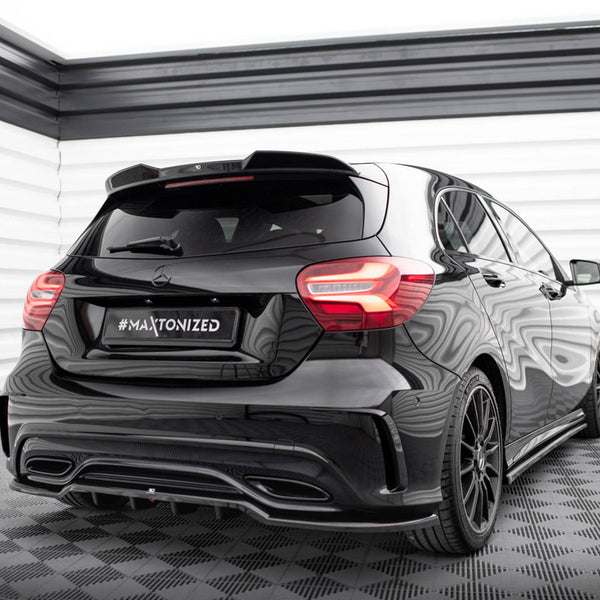 A black car stands stationary in a well-lit, sleek, checkered-floor room. The license plate reads "#MAXTONIZED," and the car features modern taillights and a reflective surface.