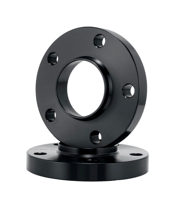 A black metal flange with multiple bolt holes lies flat, while another identical flange stands vertically, both set against a plain white background.