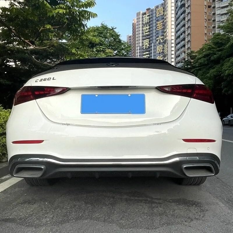 Car positioned in a parking spot, displaying rear view with "C 260 L" badge; surrounded by greenery and tall buildings with vertical signs in Chinese characters.