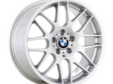 A silver alloy car wheel displays the BMW logo in the center. Surrounding it are multiple thin spokes, with 