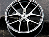 A metallic alloy wheel with a star emblem and 