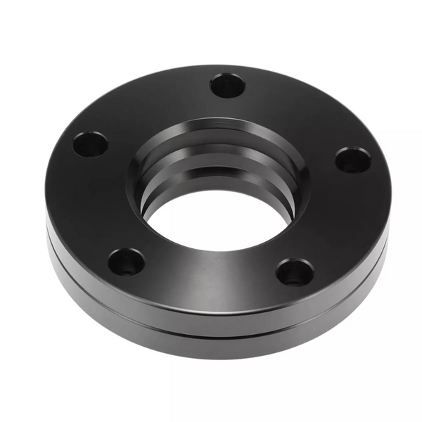 A black, circular metal flange with five bolt holes, featuring a central threaded hole, rests against a plain white background.