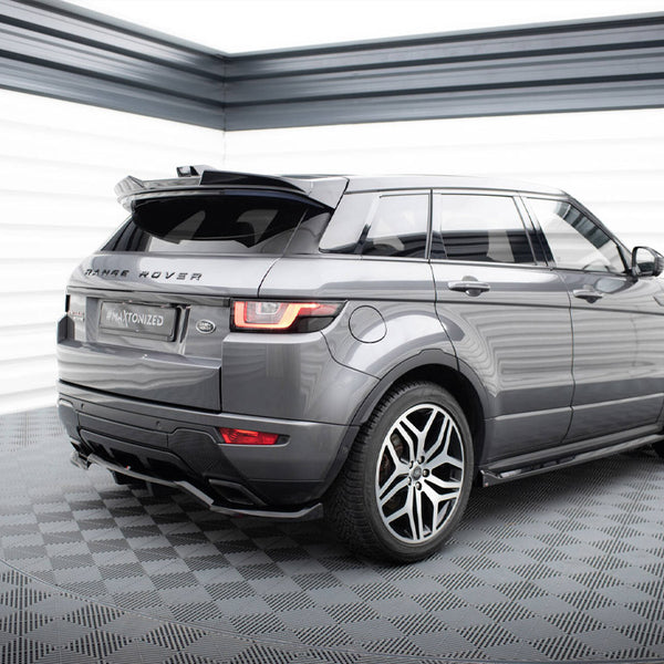 A gray Range Rover is parked on a checkered floor in a well-lit space, featuring "RANGE ROVER" text on the back and a license plate reading "#MAxtonized".