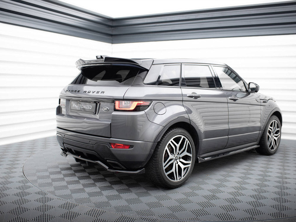 A gray Range Rover is parked on a checkered floor in a well-lit space, featuring "RANGE ROVER" text on the back and a license plate reading "#MAxtonized".