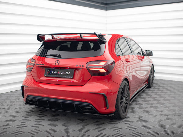 A red Mercedes A 45 AMG is stationary in a modern, brightly lit room with checkered flooring and striped walls. License plate reads "#MAXTONIZED www.maxtondesign.eu".
