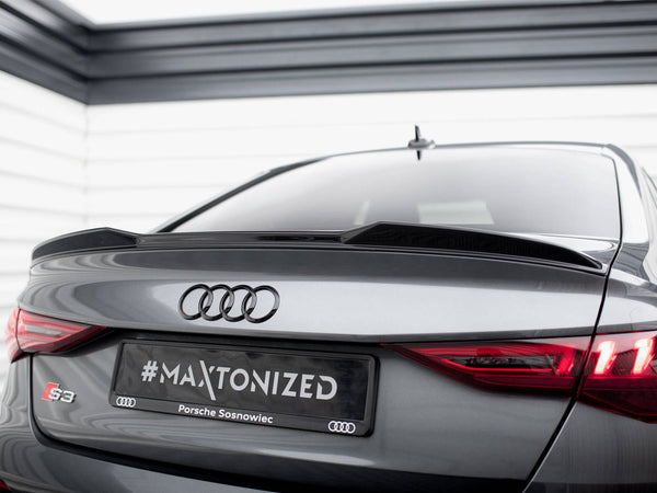 A gray Audi S3 car is parked in a garage. The rear features a spoiler, highlighted by red taillights, with a license plate reading "#MAXTONIZED Porsche Sosnowiec."