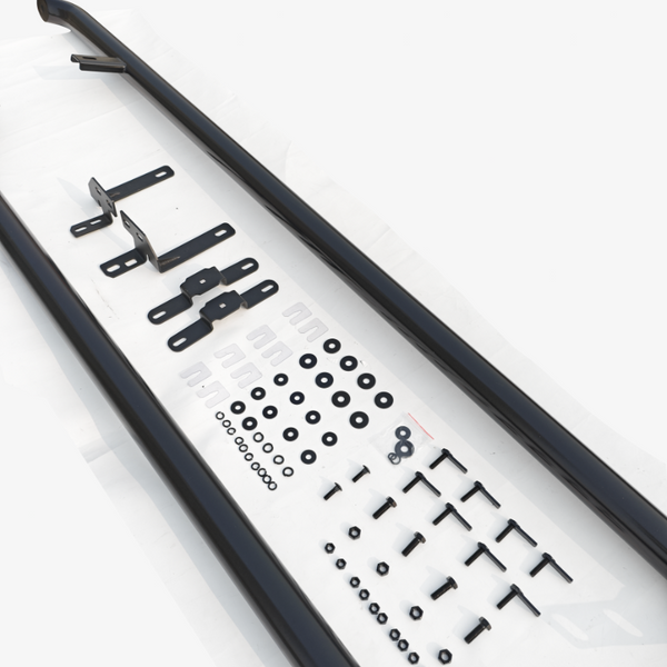 Two long black metal bars lie on a white surface, accompanied by various brackets, washers, screws, nuts, and other hardware components arranged systematically.