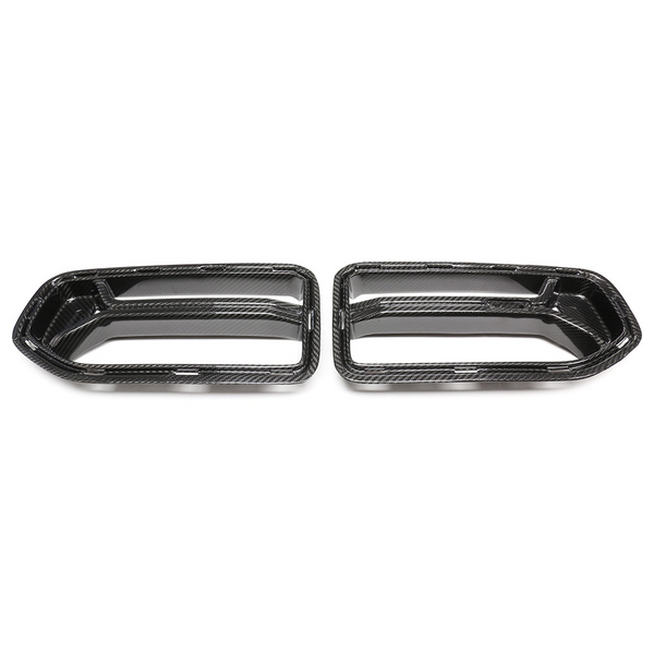 Two carbon fiber exhaust tip covers are displayed side by side on a plain white background, showcasing their sleek, aerodynamic design.