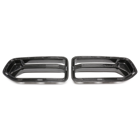 Two carbon fiber exhaust tip covers are displayed side by side on a plain white background, showcasing their sleek, aerodynamic design.