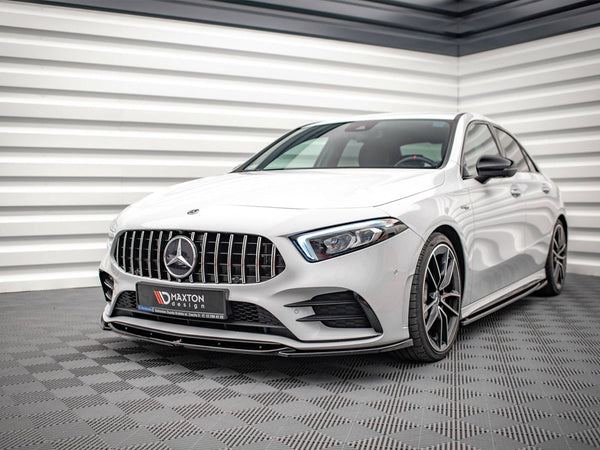 A white Mercedes car is parked on a checkered floor in a modern, sleek room with white paneled walls. The license plate reads "MAXTON design."