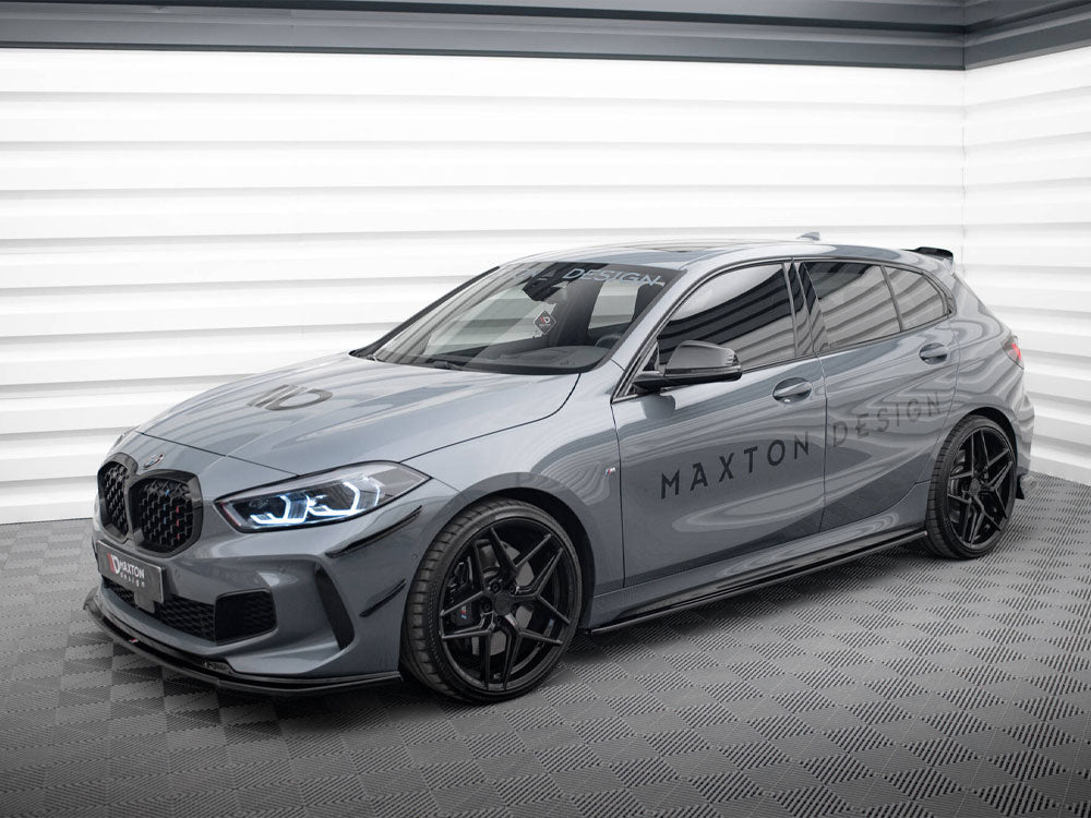 A sleek gray hatchback car with sporty black wheels is parked in a well-lit garage. The words "MAXTON DESIGN" are prominently displayed on its side and windshield.