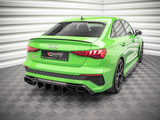 A vivid green Audi RS3 is parked in a brightly lit room with white paneled walls and a patterned floor. License plate reads: 