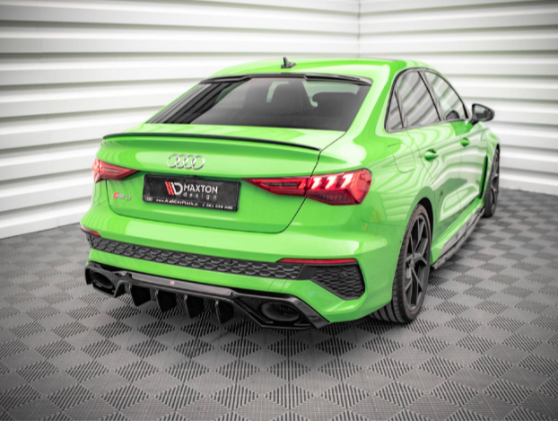A vivid green Audi RS3 is parked in a brightly lit room with white paneled walls and a patterned floor. License plate reads: "MAXTON DESIGN, www.maxtondesign.eu, tel. 48 34 325 93 40".