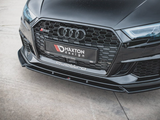 A black car's front grille displays its brand logo with a sleek design. The license plate reads 