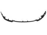 A black car bumper lip spoiler is laid on a plain white background. The structure curves upward at both ends, with several mounting points along its length.