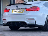 A white BMW M4 is parked outside a modern building. The car's license plate reads 