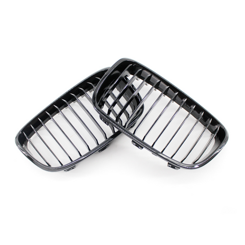 Two black vehicle grille covers, resting against each other, feature vertical slats, set against a plain white background.