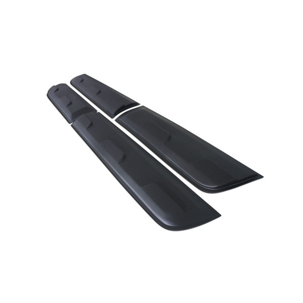 Long black car side skirts lie parallel on a plain white background, featuring subtle grooves and slightly raised sections for attachment or aerodynamic purposes.