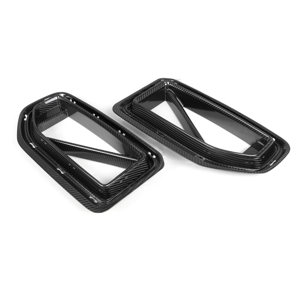 Rectangular carbon fiber car air vents lie side by side, featuring diagonal support bars. They rest on a plain white background, highlighting their sleek design and textured pattern.