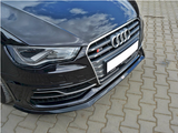 A black car front features a stylized grille with four rings and an 