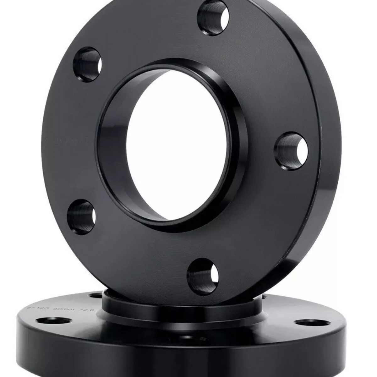 A black circular metal flange with a central hole and multiple bolt holes is displayed in front of a similar flange, set against a plain white background.