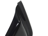 A glossy black high-heeled shoe with a sharp heel edge is positioned against a plain white background. The focus is on the rear and top section of the heel.