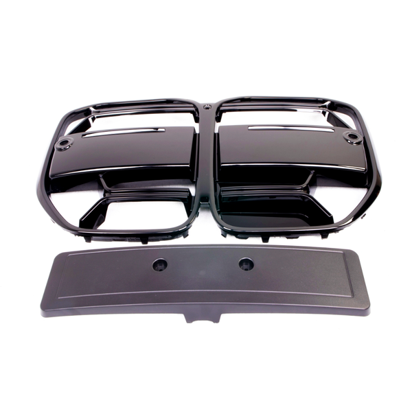 Black plastic grille with two rectangular openings placed above a rectangular cover featuring two circular holes, on a plain white background.