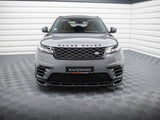 A Range Rover is parked in a modern showroom with a checkered floor and white walls. The grille and headlights are prominent. Text on the front reads: “#MAXTONIZED.”