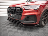 A red car with a distinctive black grille and logo is parked on a patterned gray floor. The context is a modern showroom with white, ribbed walls. Text reads 