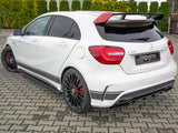White Mercedes-Benz A45 AMG with a rear spoiler and black alloy wheels parked on a paved driveway. Background features neatly trimmed green hedges. License plate reads 